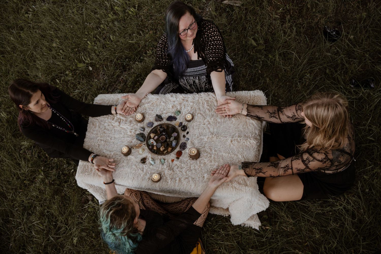 Overhead view of a styled maternity session with blankets and fall decorations under a tree.