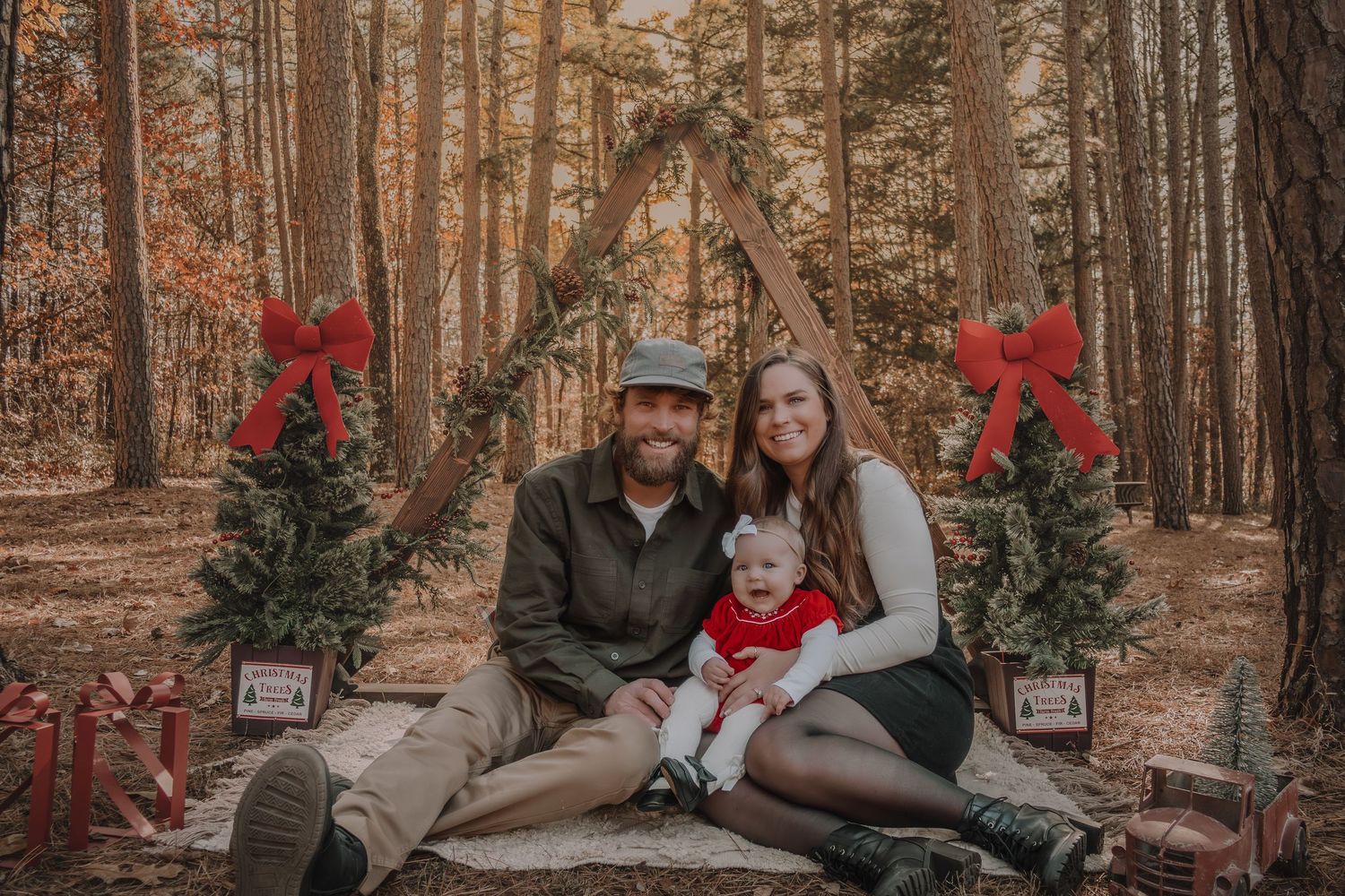 A series of fall family photos captured in a forest setting with warm autumn colors and red bows as decorative accents.