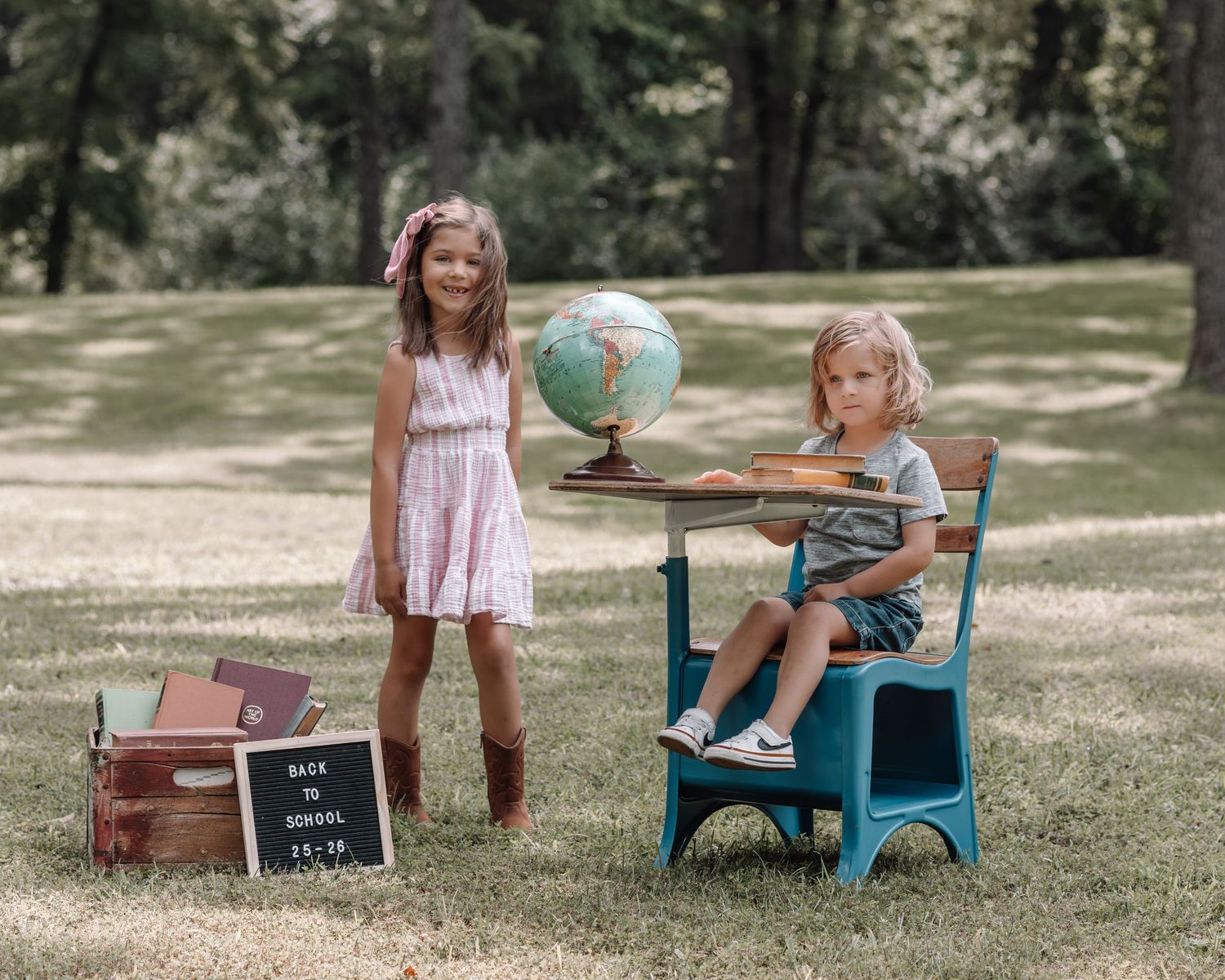 A series of vintage-styled back to school photos featuring a teal bench and brown suitcase props on grass outdoors.
