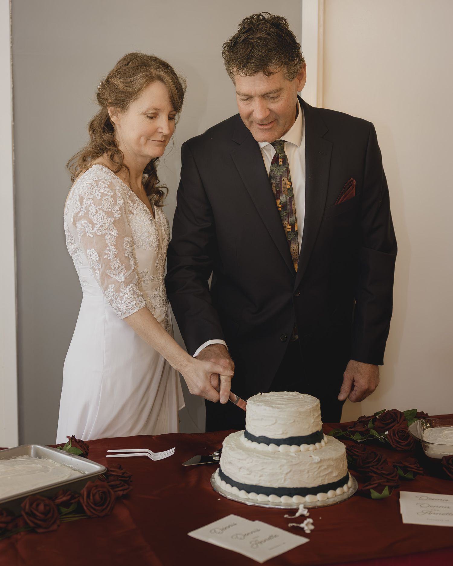 A sequence of wedding cake cutting moments captured in warm indoor lighting.