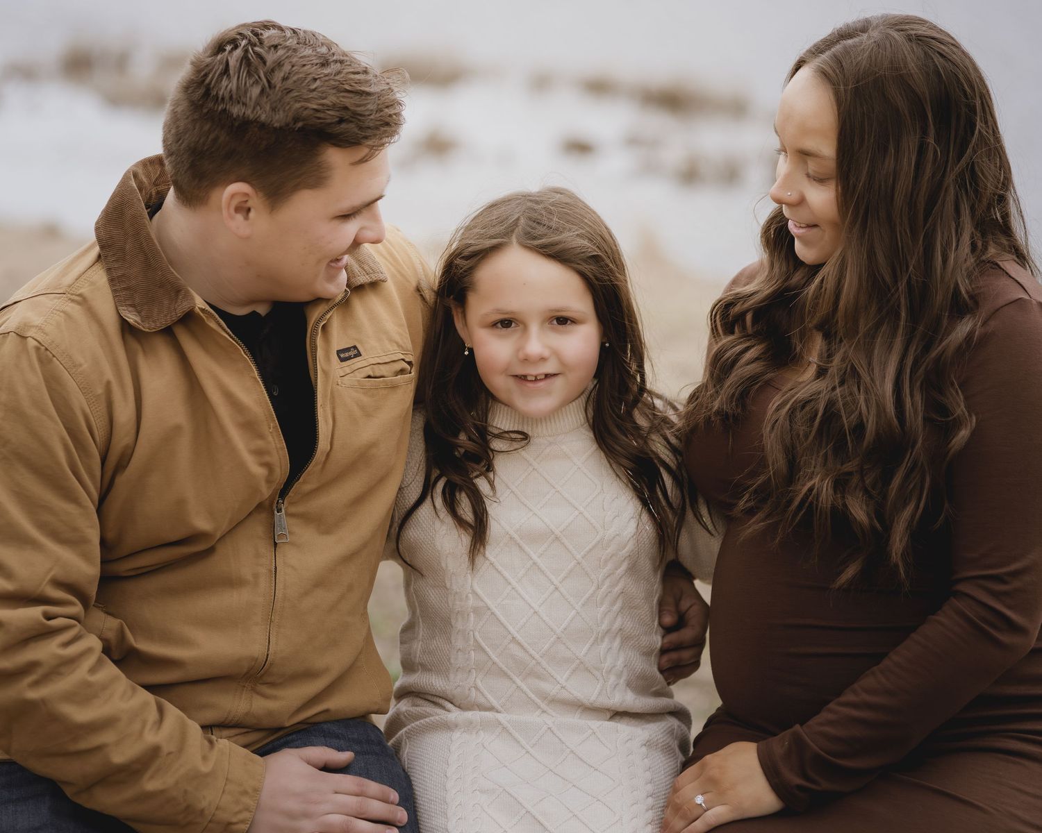 Intimate autumn portrait series showing tender moments between people in coordinating brown and cream outfits.