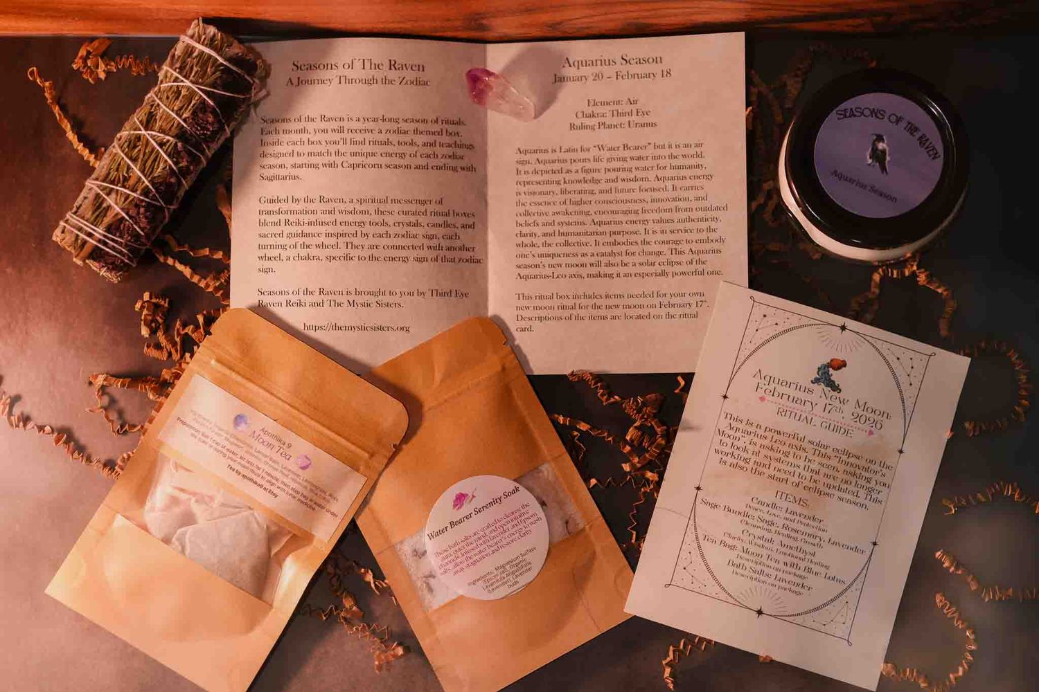 Herbal ritual kit with sage bundle, kraft pouches, candle tin, and printed spell cards on rustic background.
