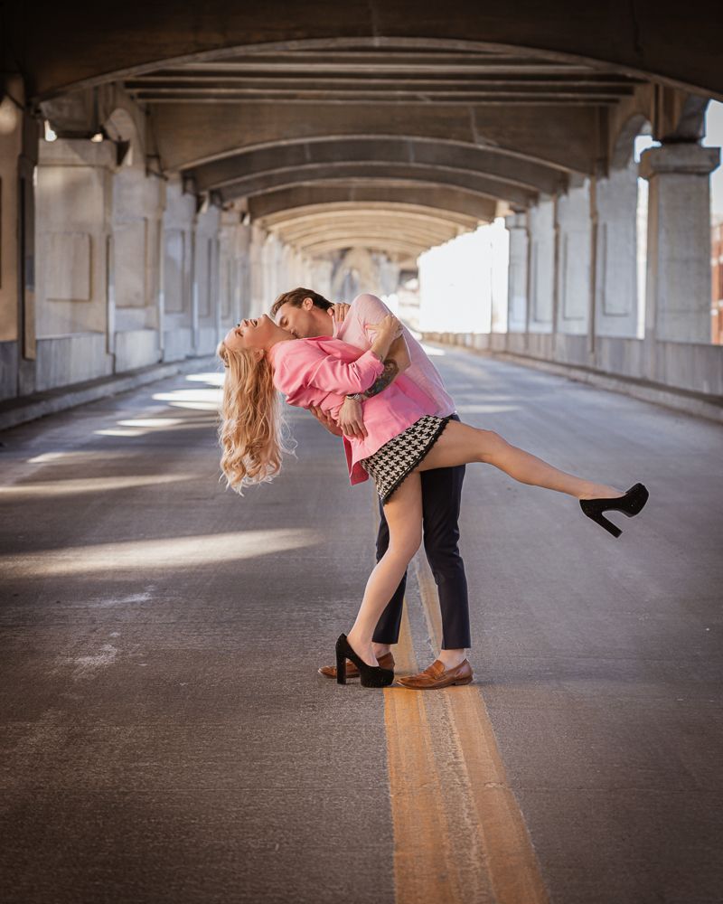 A romantic dance sequence shows a couple in an arched tunnel with dramatic lighting and shadows.