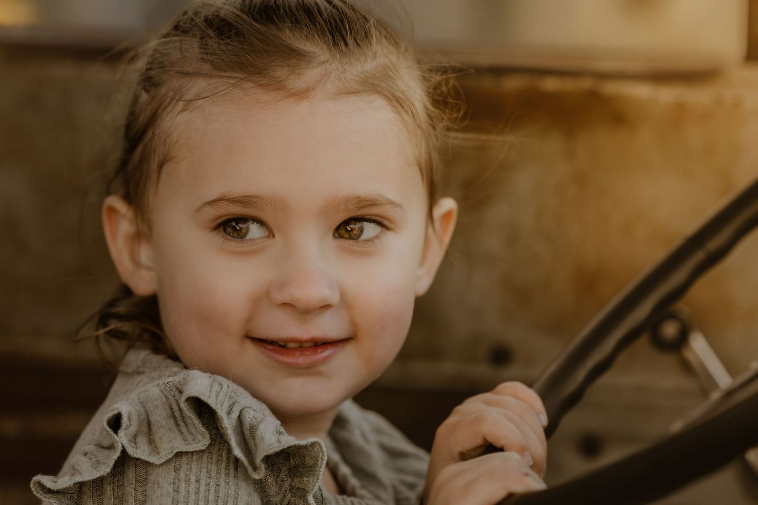 Close-up portrait shot with warm golden lighting and soft focus.