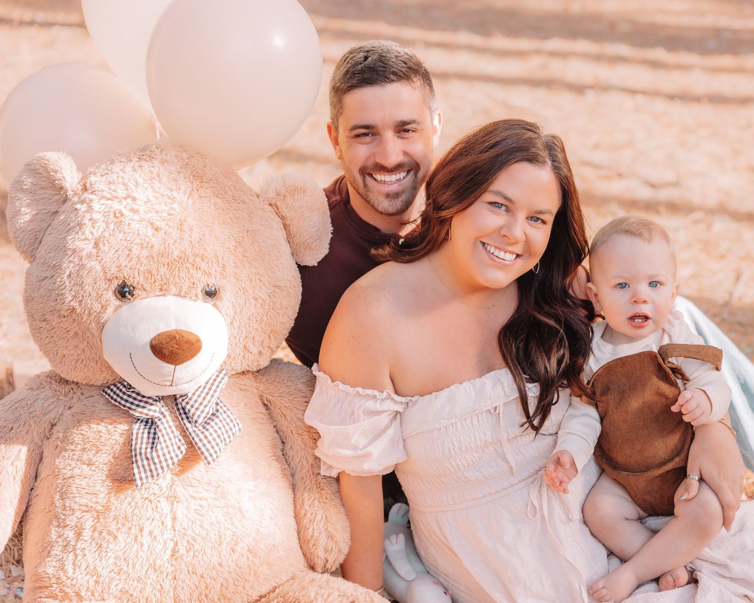 A heartwarming outdoor family moment captured in warm sepia tones among pine trees.