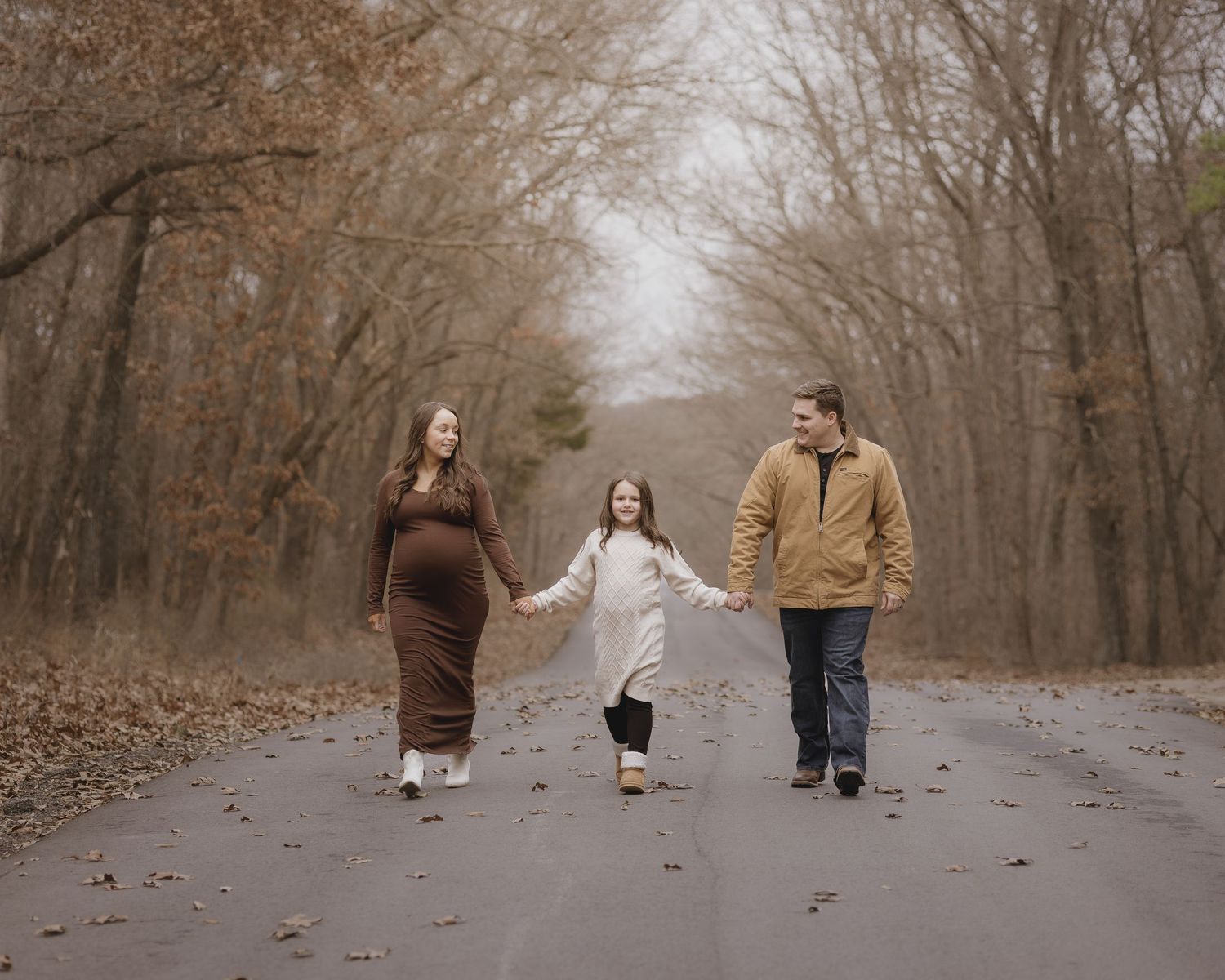 A collection of romantic outdoor photos showing a couple walking together on a leaf-covered path in autumn.