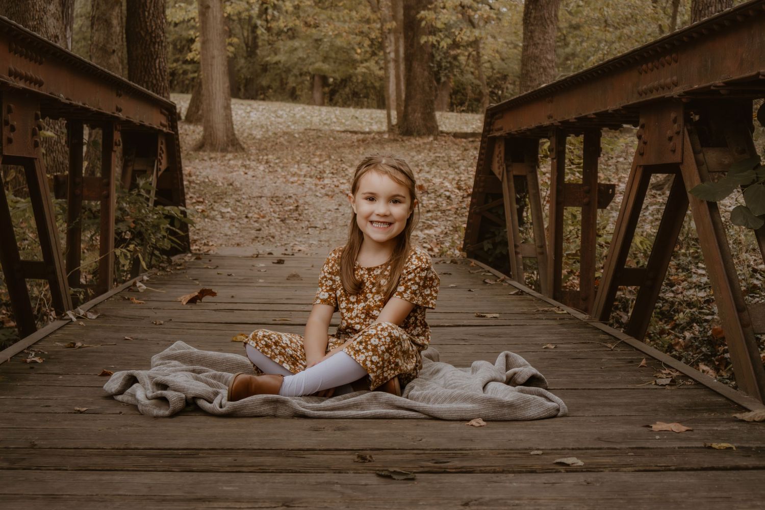 A series of connected outdoor portrait photos taken on a rustic wooden bridge in a forest setting.