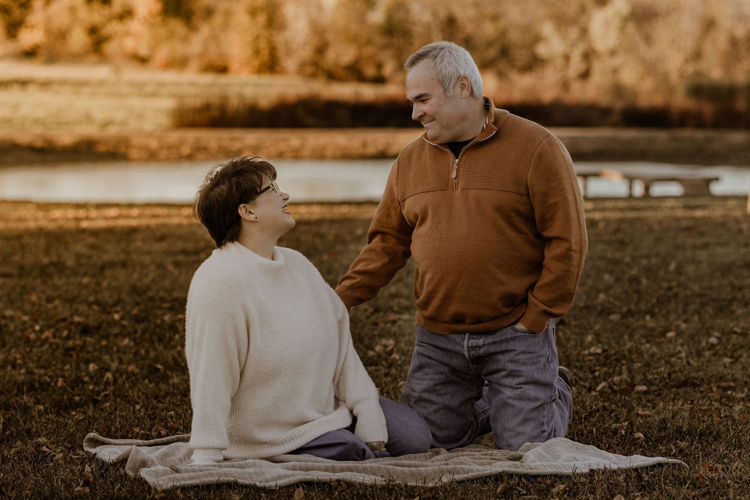 Casual outdoor family photography session with warm sunset lighting in a park setting.