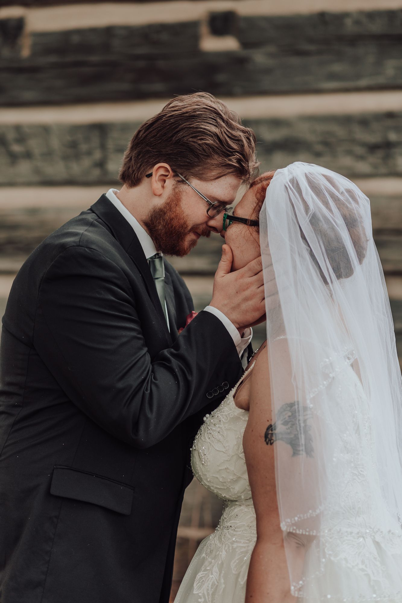 Intimate moment captured between newlyweds during outdoor wedding ceremony.