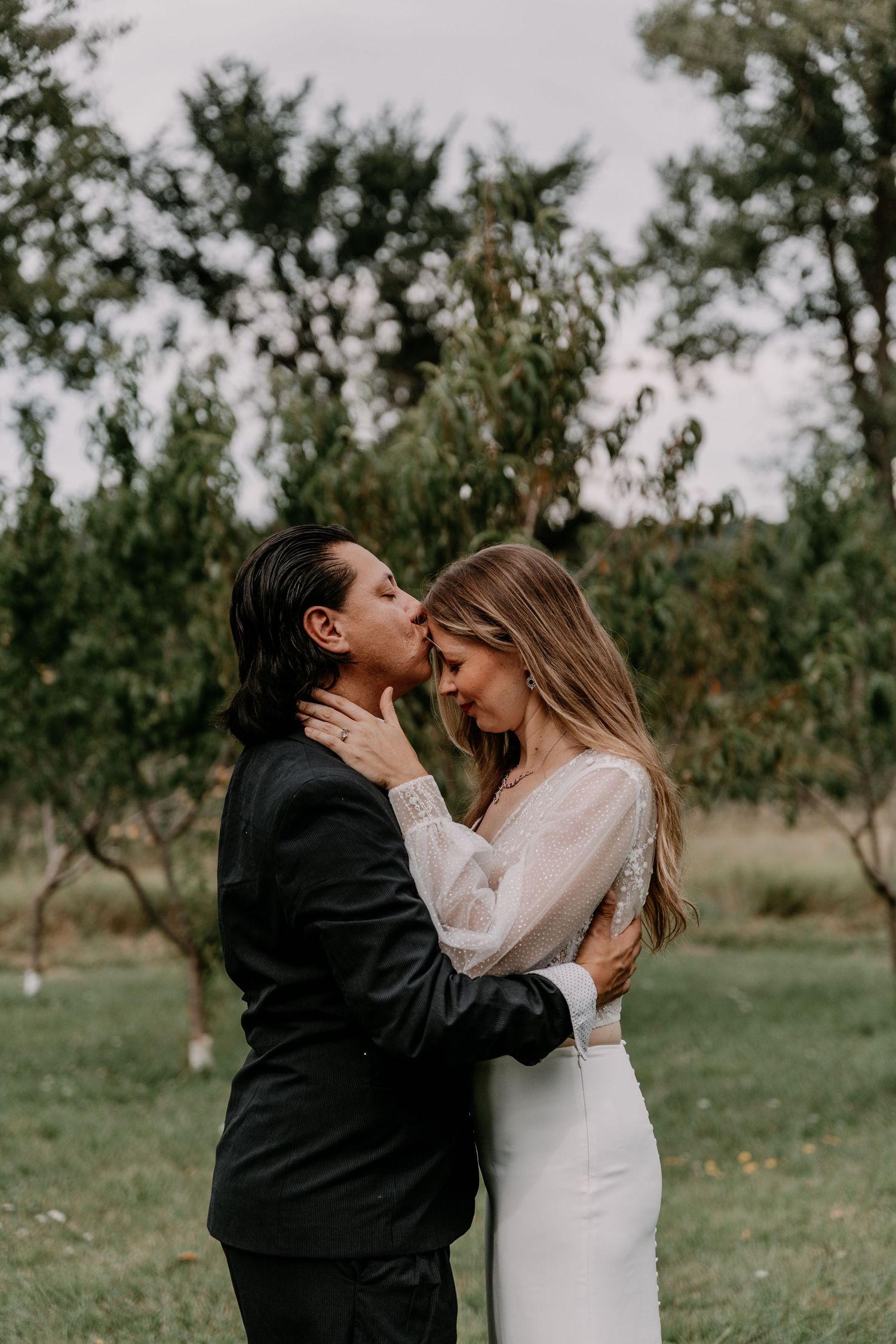 Intimate romantic moment between couple in garden setting.