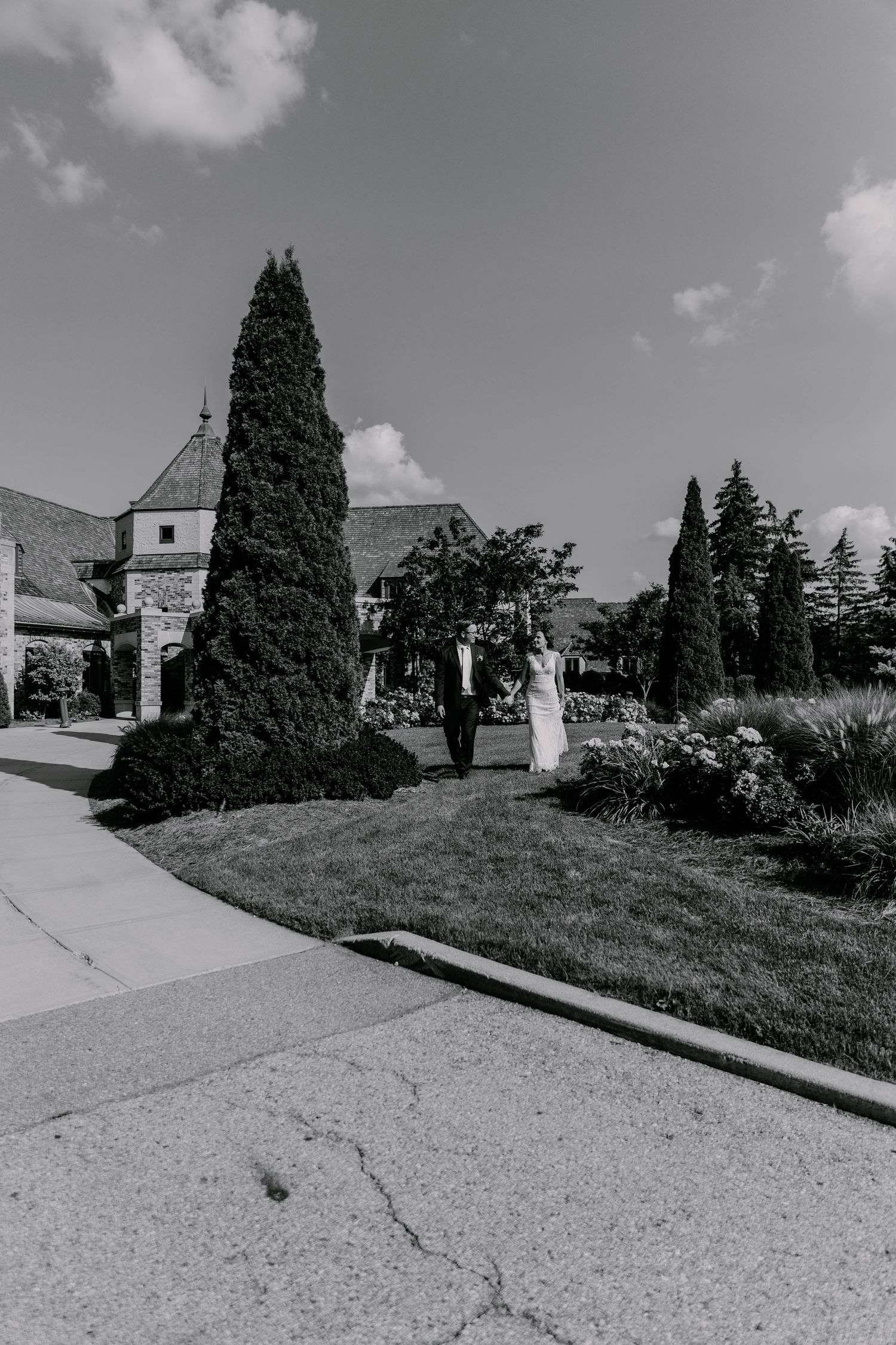 Black and white landscape of church grounds with tall cypress trees and garden paths.