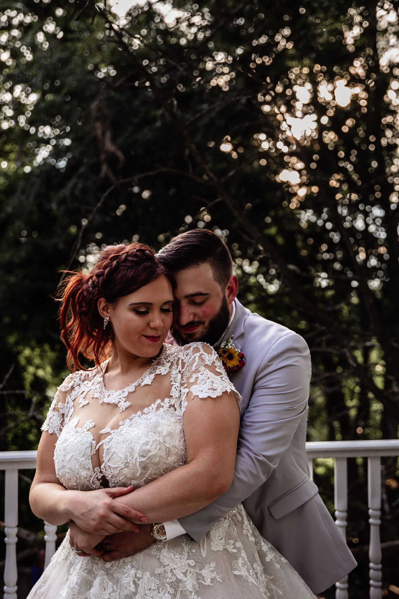 Intimate wedding moments captured on an outdoor white deck with forest scenery in the background.