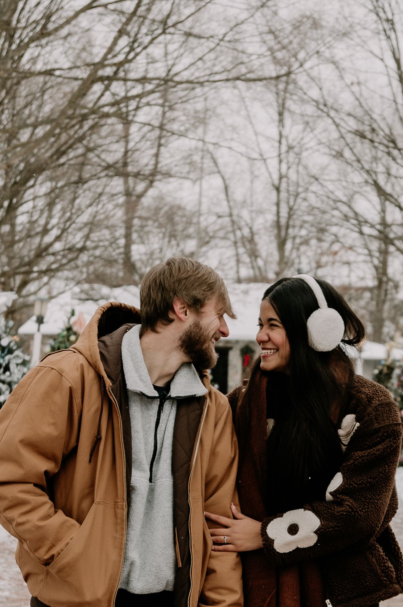 A couple in winter attire sharing intimate moments in a snowy outdoor setting, shown in a four-panel sequence.