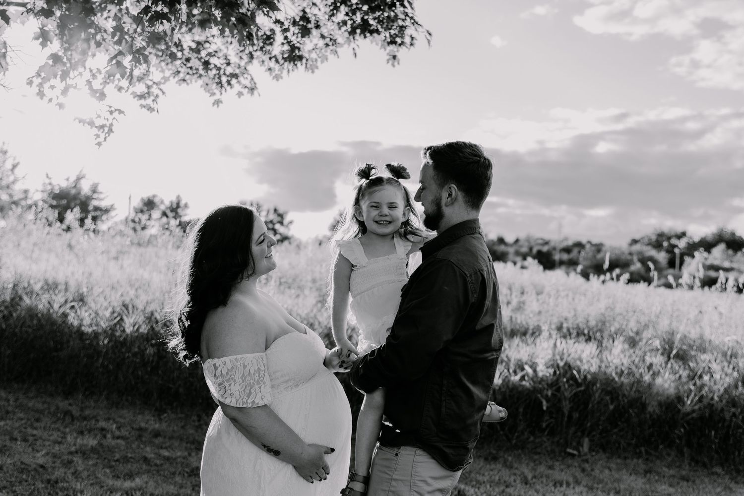 A series of black and white wedding photographs showing romantic outdoor scenes with a natural landscape backdrop.