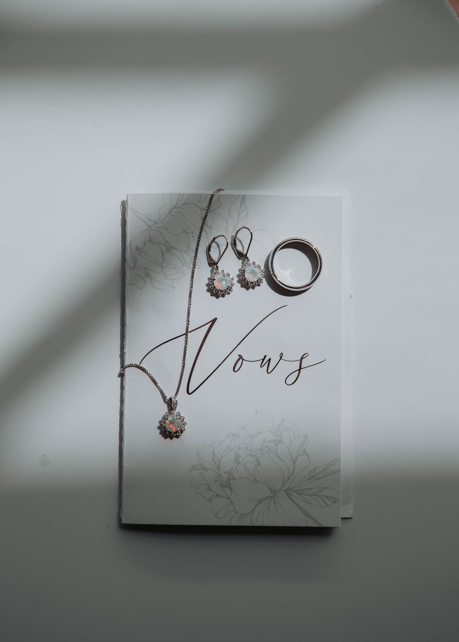Wedding vows written in elegant calligraphy on white paper with delicate floral design.