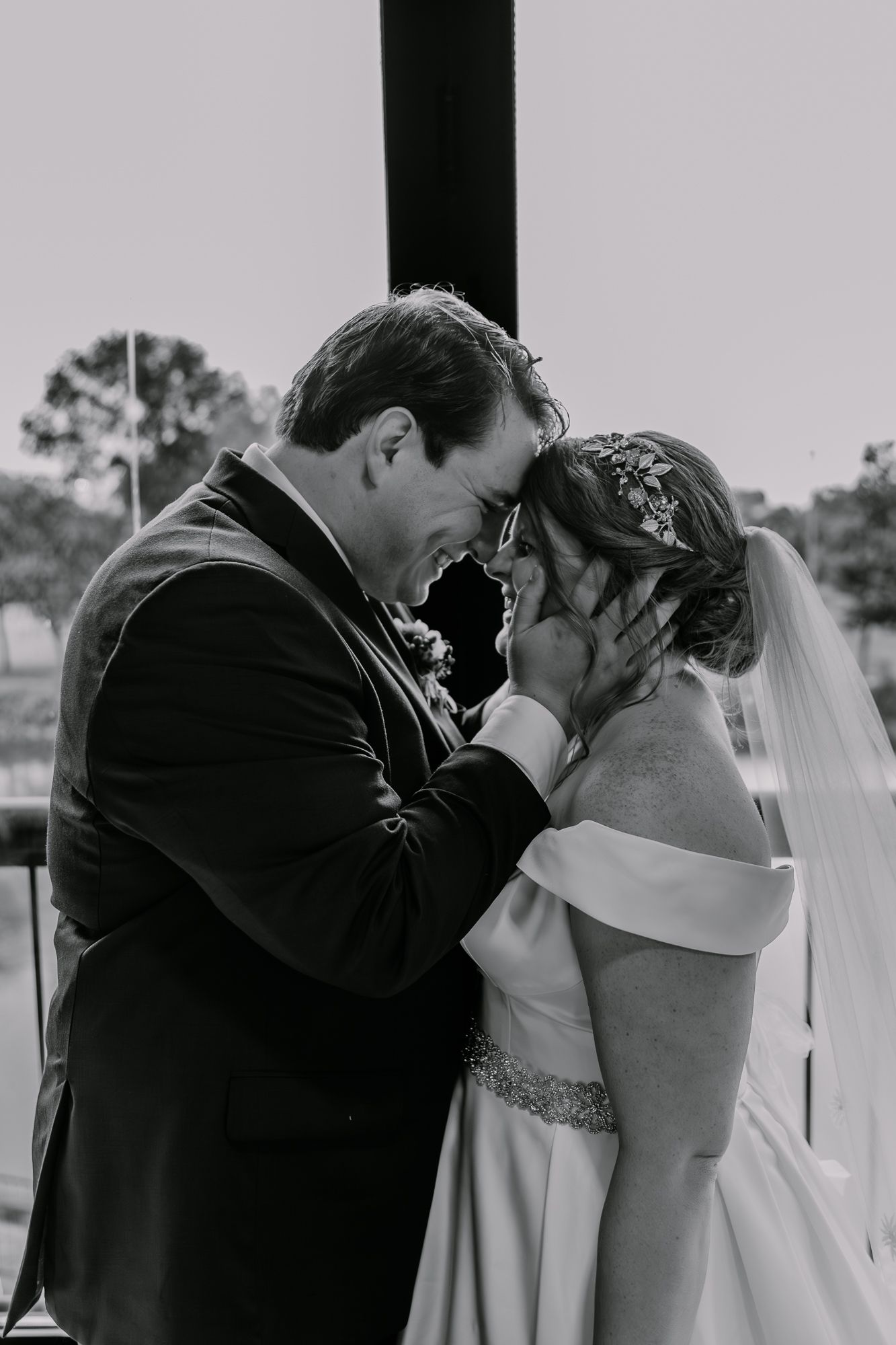 Artistic black and white series captures tender wedding moments between newlyweds.
