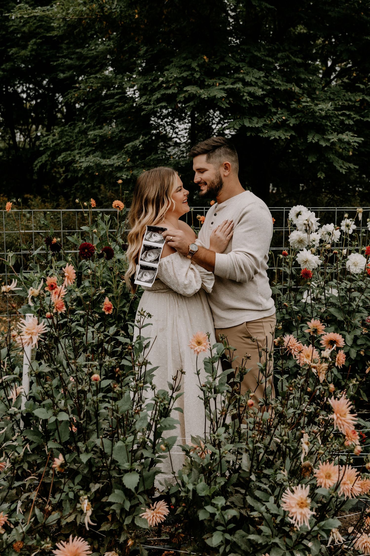 Romantic moments captured in flower garden with mix of white and orange blooms.