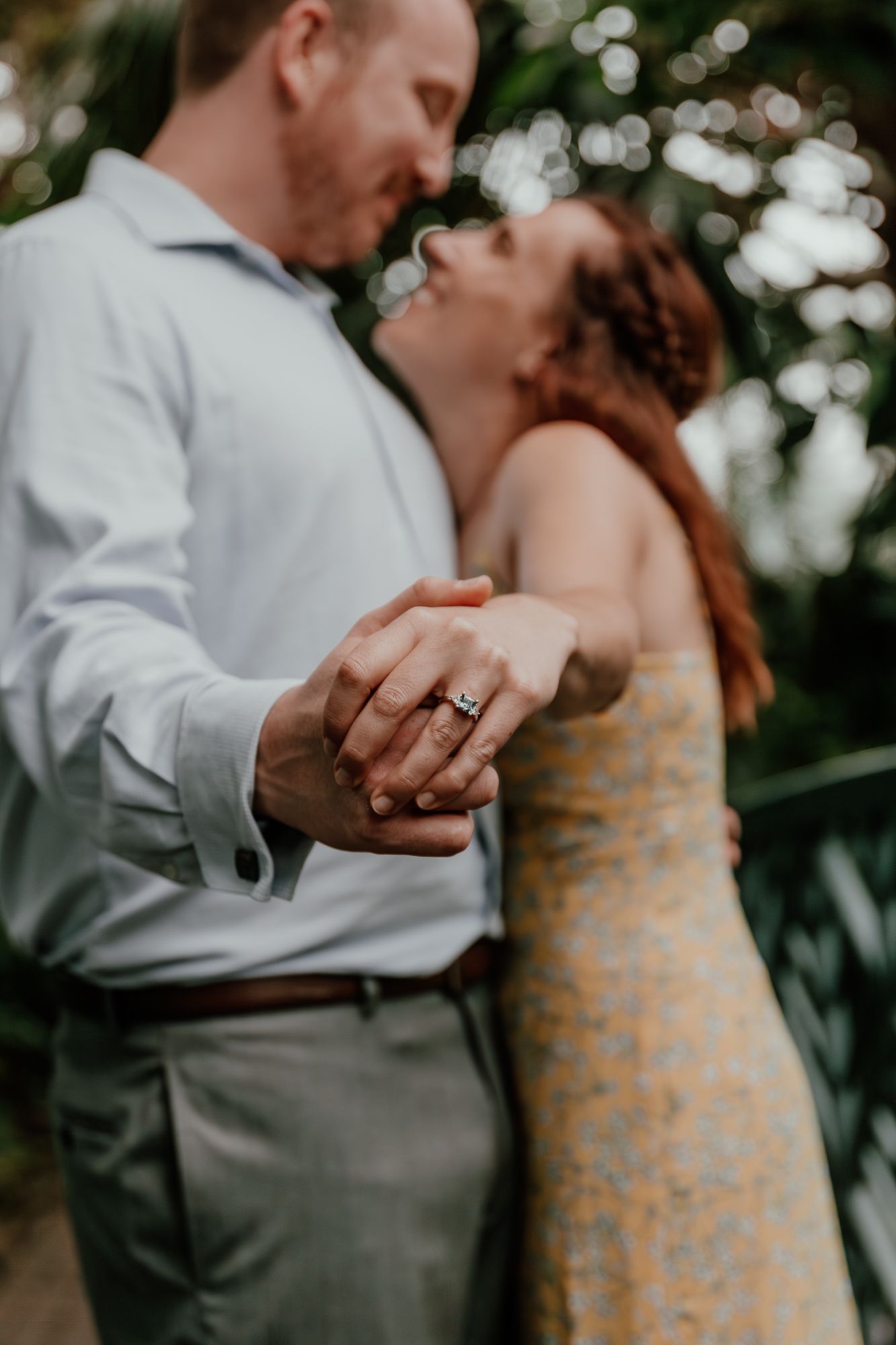 Close-up shot of a couple dancing, showcasing their wedding rings.
