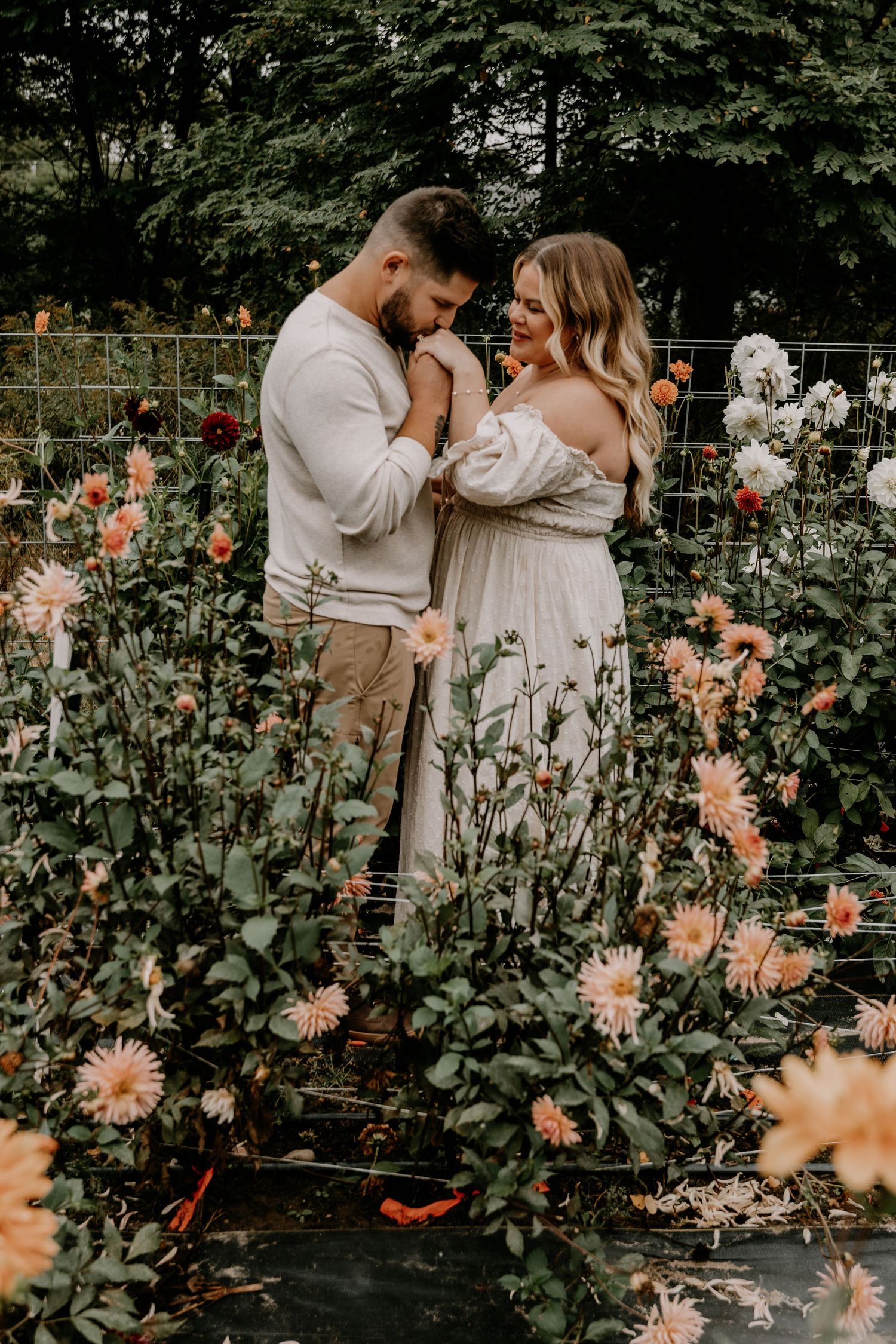 Beautiful floral garden scene with peach-colored dahlias framing a romantic moment.