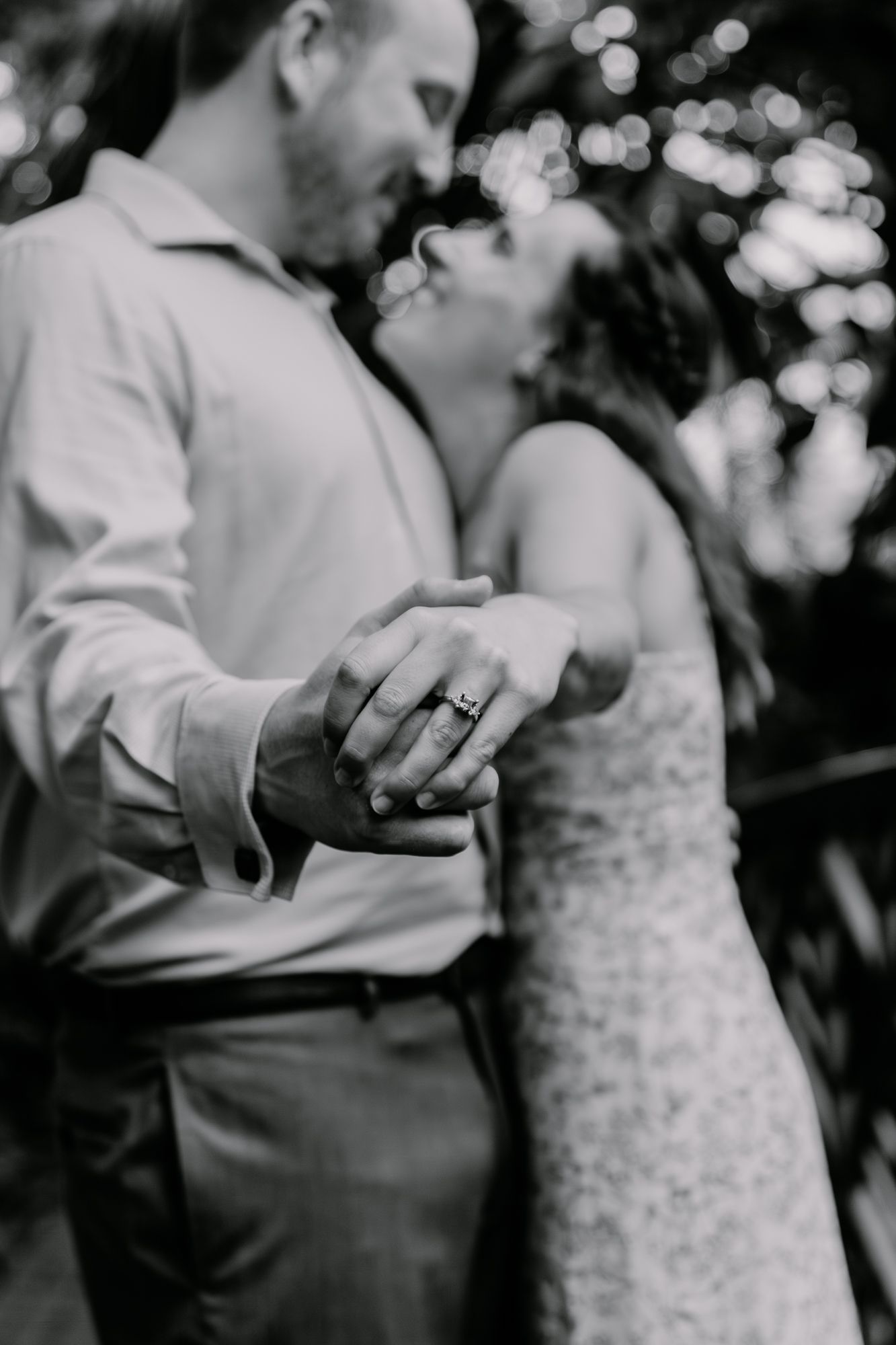 A romantic black and white photo of a couple dancing closely together.