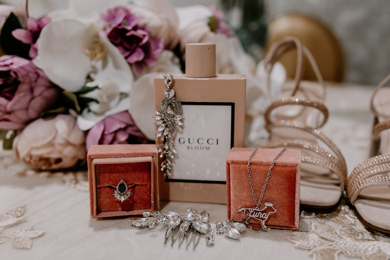 Wedding accessories and luxury brand gift boxes arranged on display.
