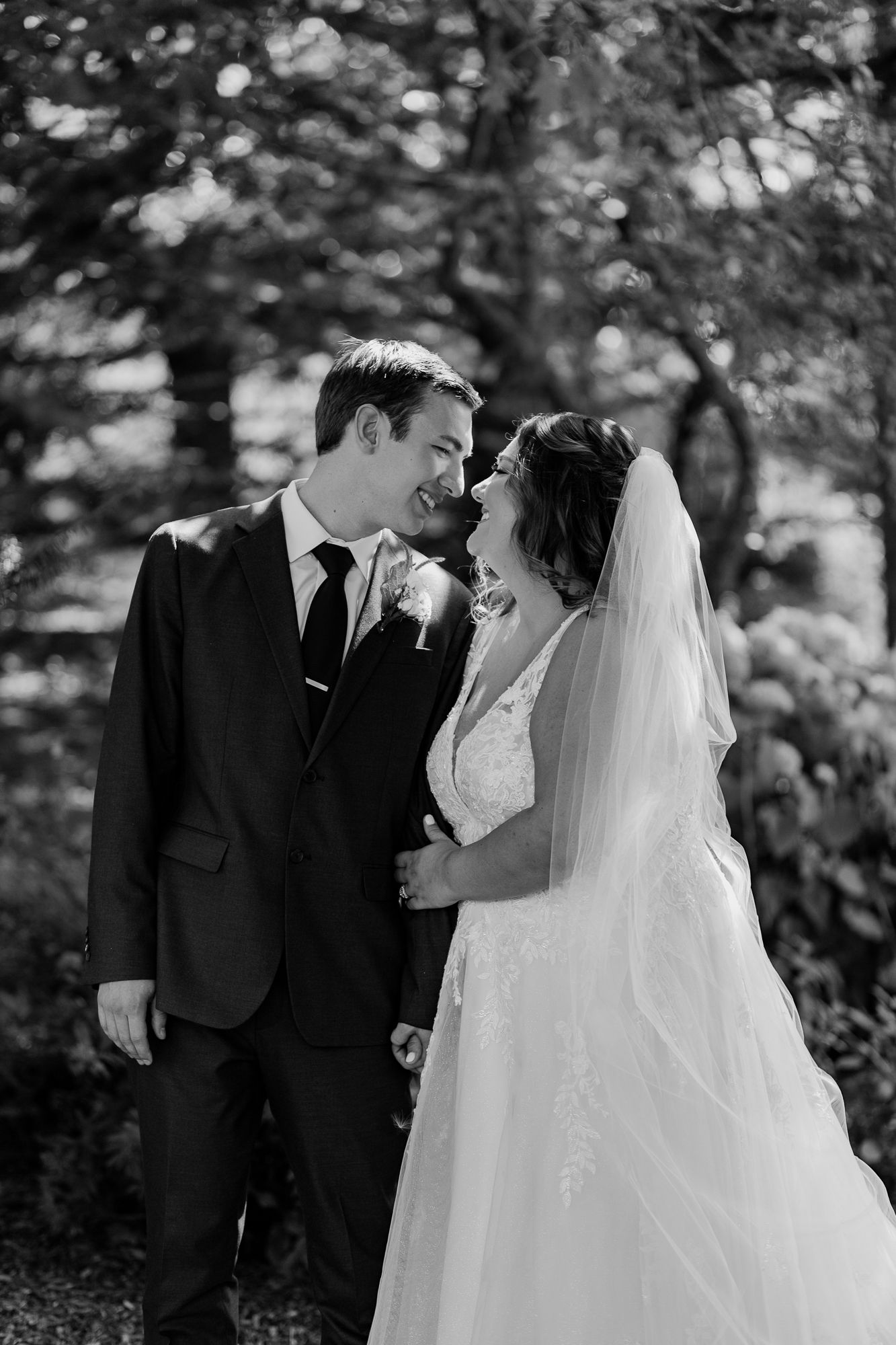 Black and white portrait of wedding couple sharing a tender moment.