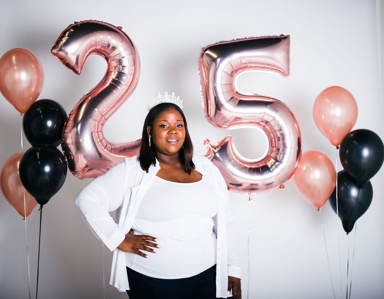 Birthday celebration setup with black and rose gold balloons and number decorations.