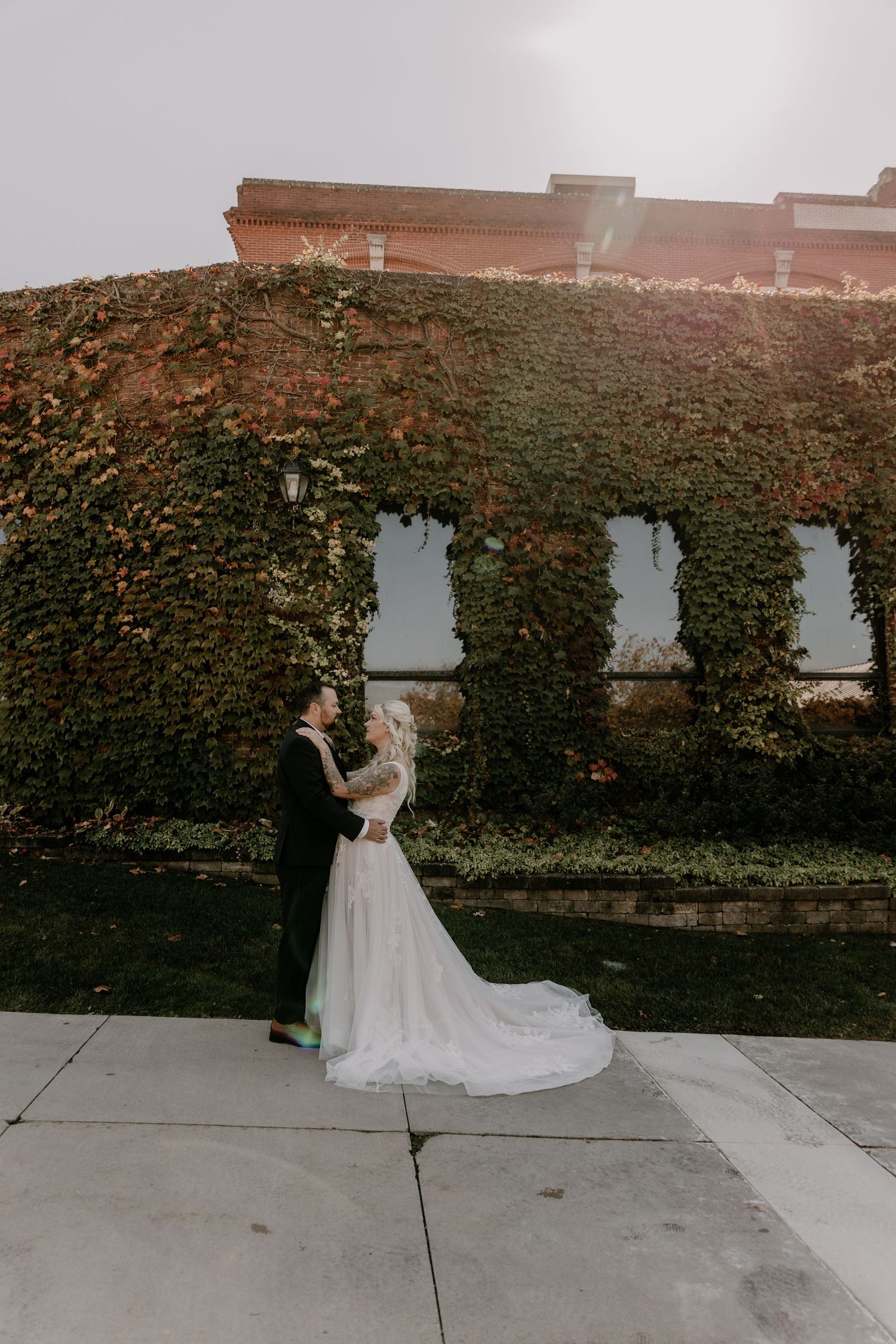 A wedding couple poses against an ivy-covered wall in an artistic sequence of photos.
