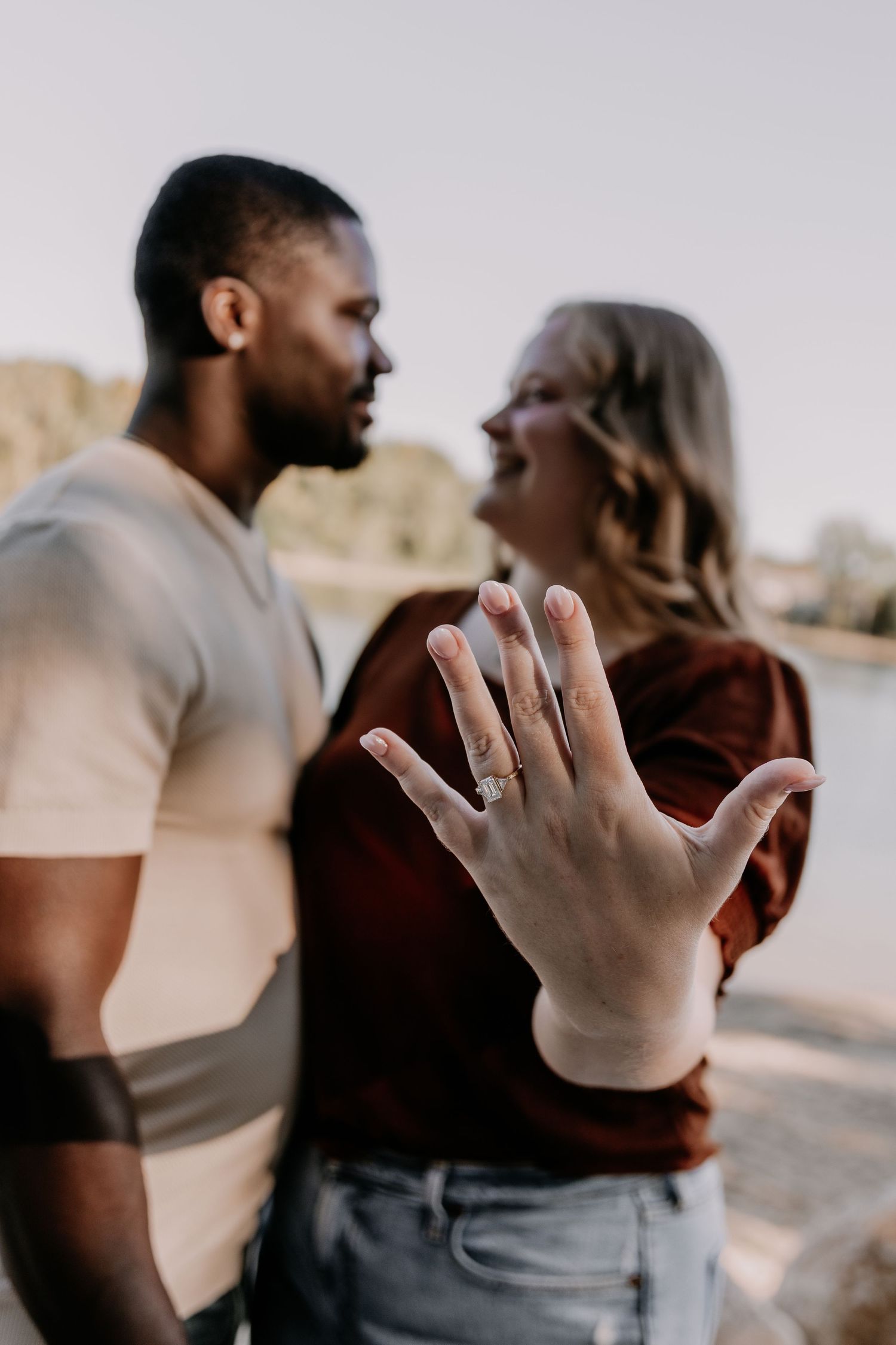 Series of photos showing hands with engagement rings in intimate poses against a blurred outdoor background.