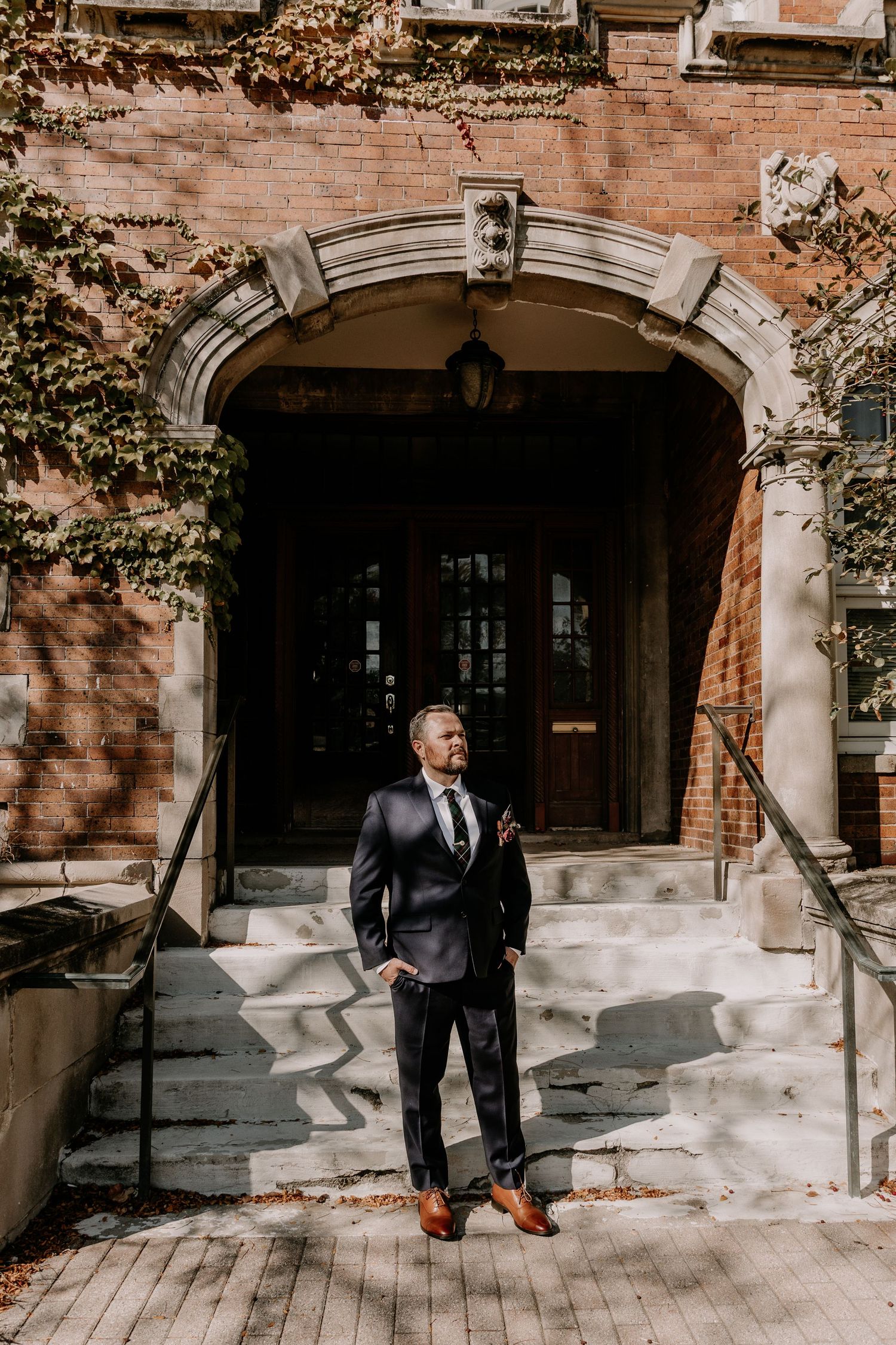 A series of five progressive shots showing someone walking into an arched doorway of a historic stone building.
