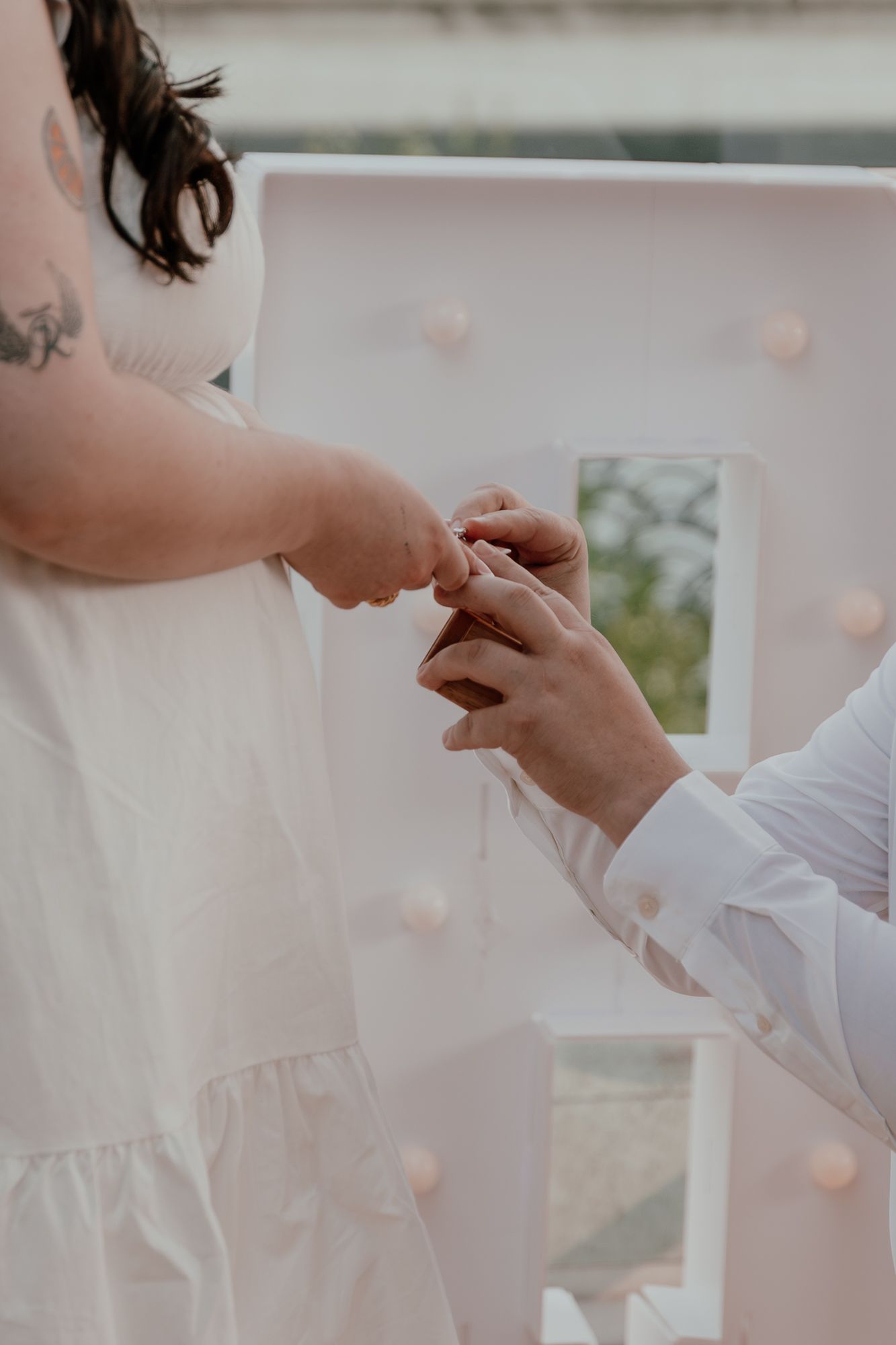 Close-up of engagement ring being placed on finger during romantic proposal.