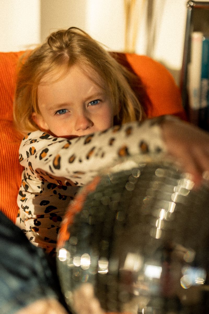 Sequence showing interaction with a sparkly disco ball in warm orange tones.