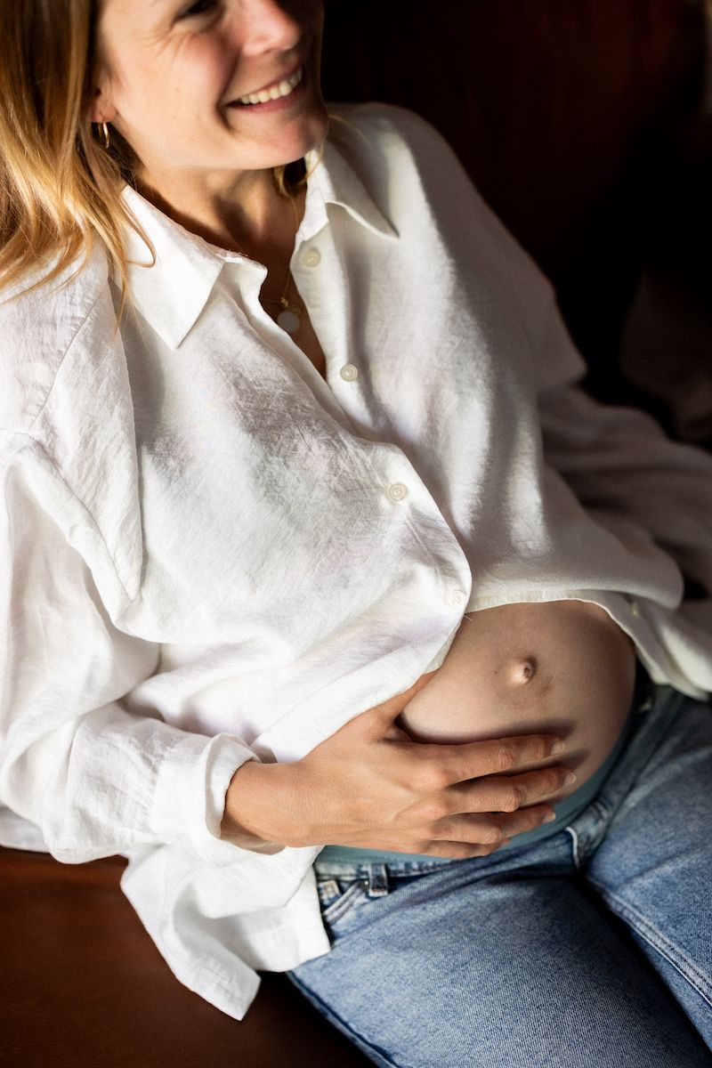 Casual portrait series showing white shirt and denim in natural indoor lighting.