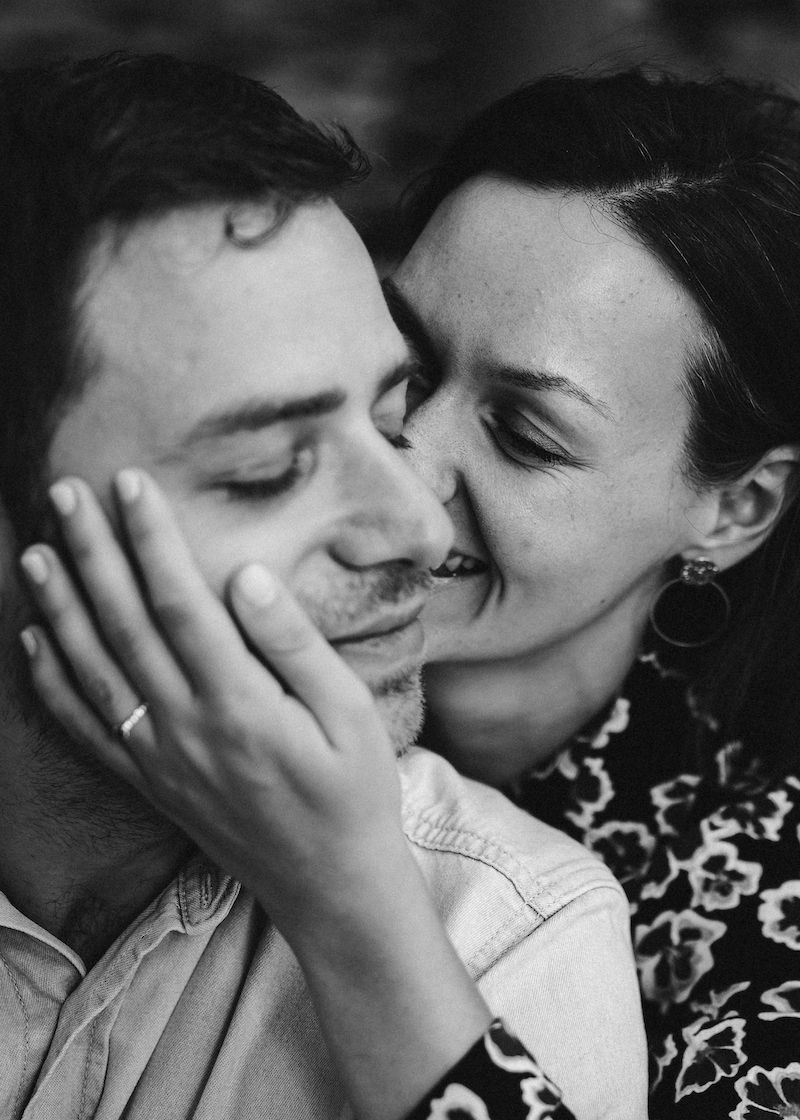 Intimate black and white romantic portrait of couple embracing.