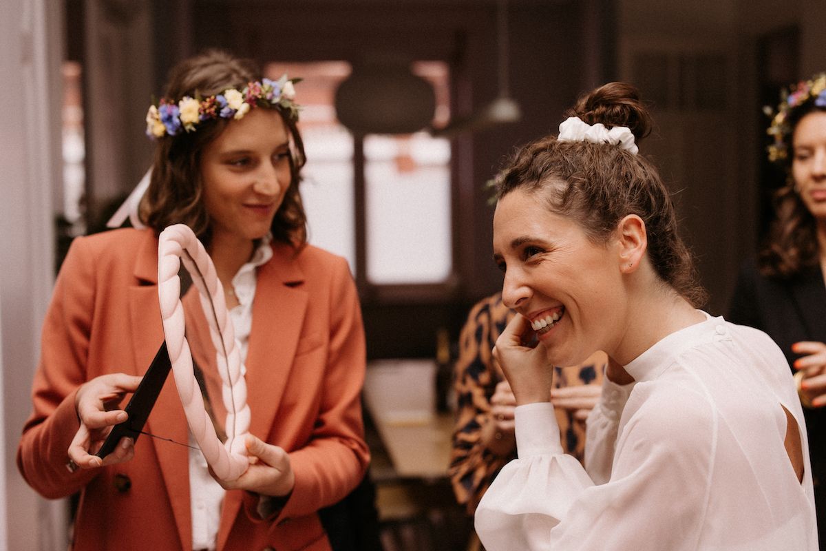 Candid celebration moment with guests wearing flower crowns.
