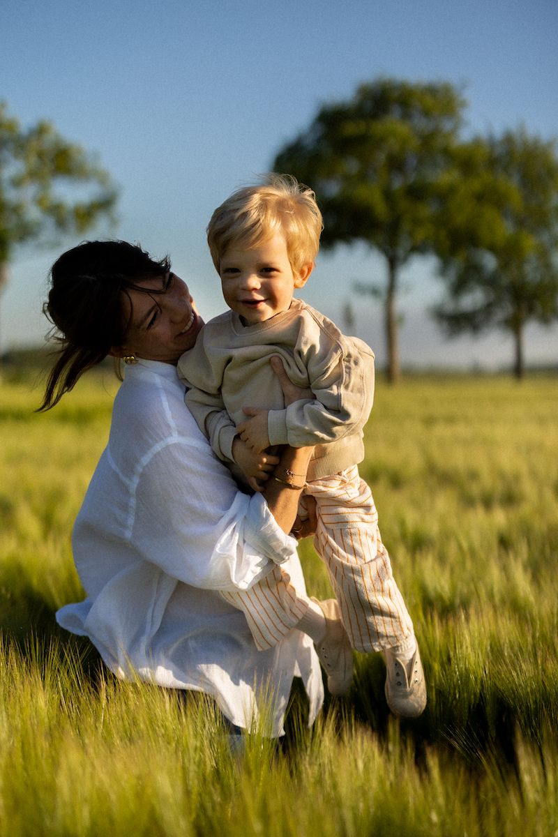 Tender embrace captured in sunlit wheat field on a bright summer day.