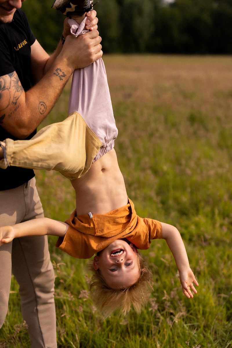 Joyful playtime moment showing playful interaction in a sun-lit grassy meadow.