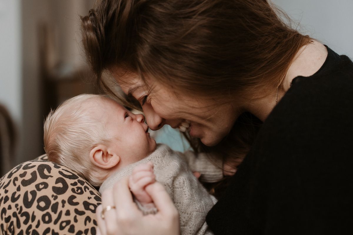 Tender moment captured in soft natural lighting with gentle expressions.