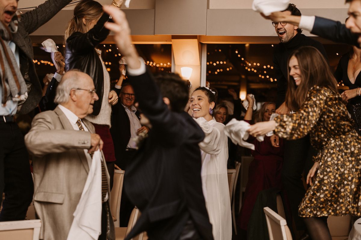 Lively dance party with guests of all ages enjoying themselves at an indoor reception.
