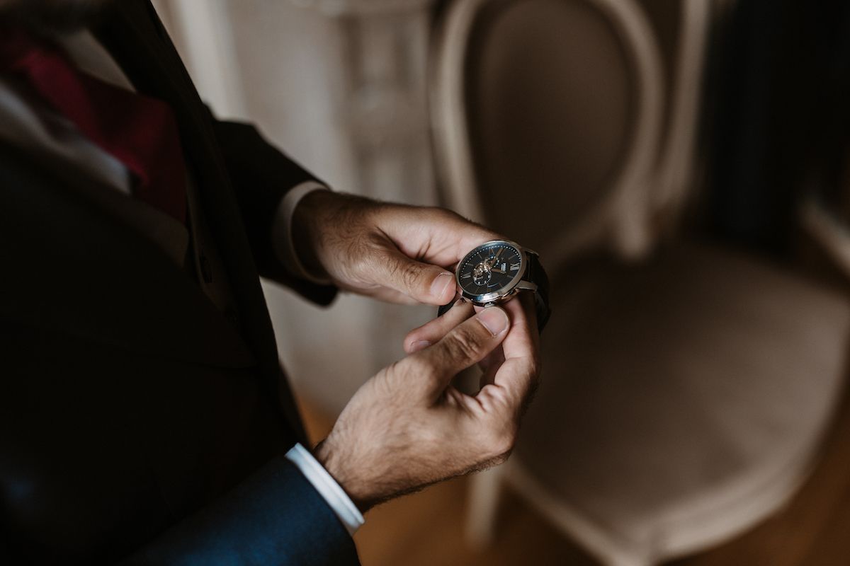 Close-up shots of hands holding wedding rings in dramatic lighting.