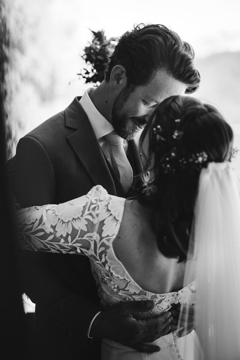 Intimate black and white wedding portrait showing tender embrace.