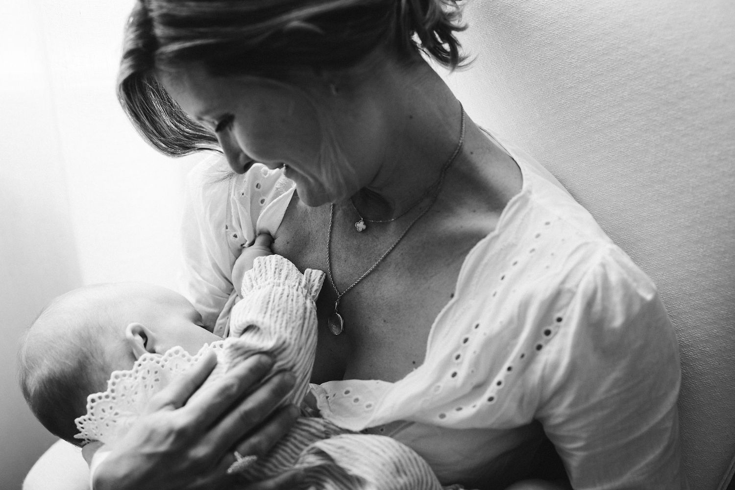 Intimate black and white portrait capturing a gentle nurturing moment.