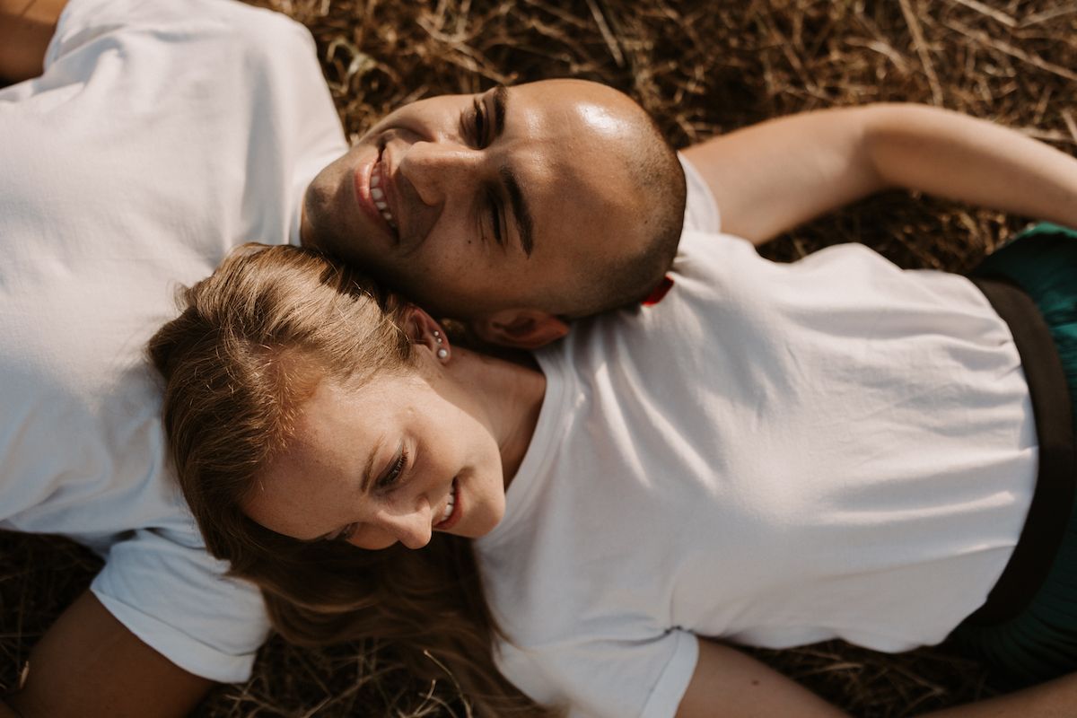 Intimate couple's portrait on dark textured background.