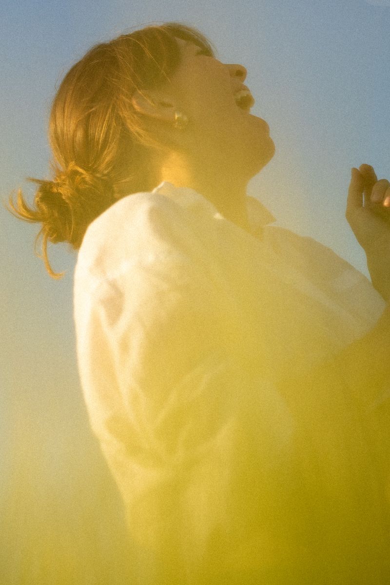 Silhouette of person in backlit sunlight creating dreamy atmosphere.