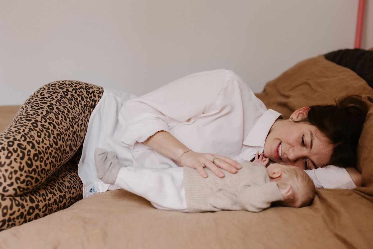 Relaxing scene on a bed with leopard print pillows and white bedding.