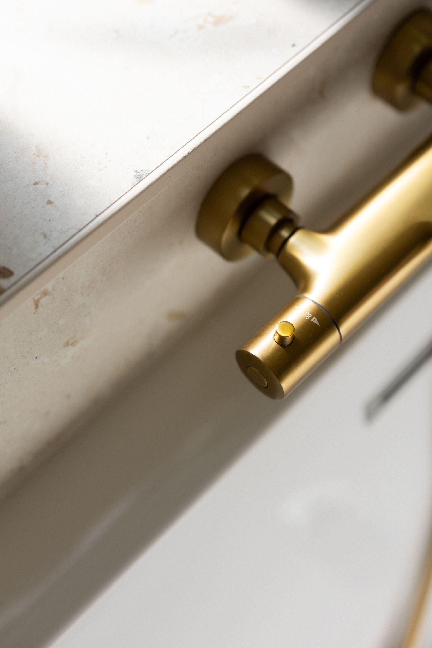 Detailed view of a gold-colored metal fixture or hardware component.