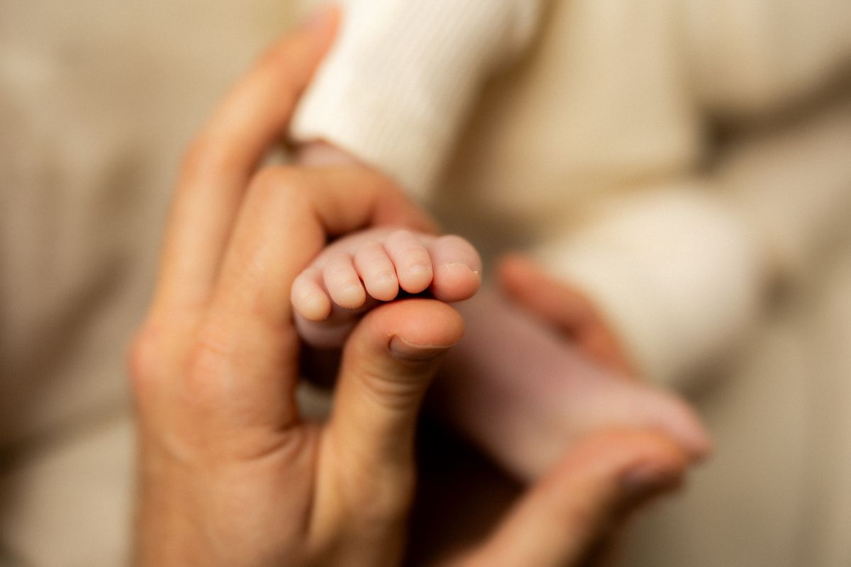 Close-up shots of tiny baby feet and hands against a light background.