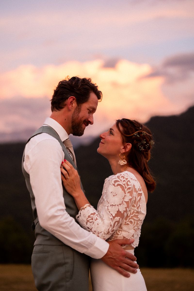 Romantic sunset moments at a rustic outdoor wedding celebration.
