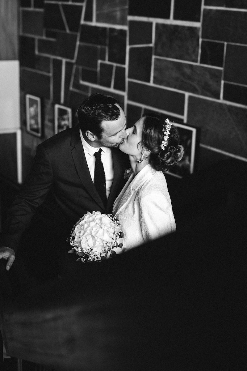 A series of romantic wedding photos showing a couple kissing in black and white.