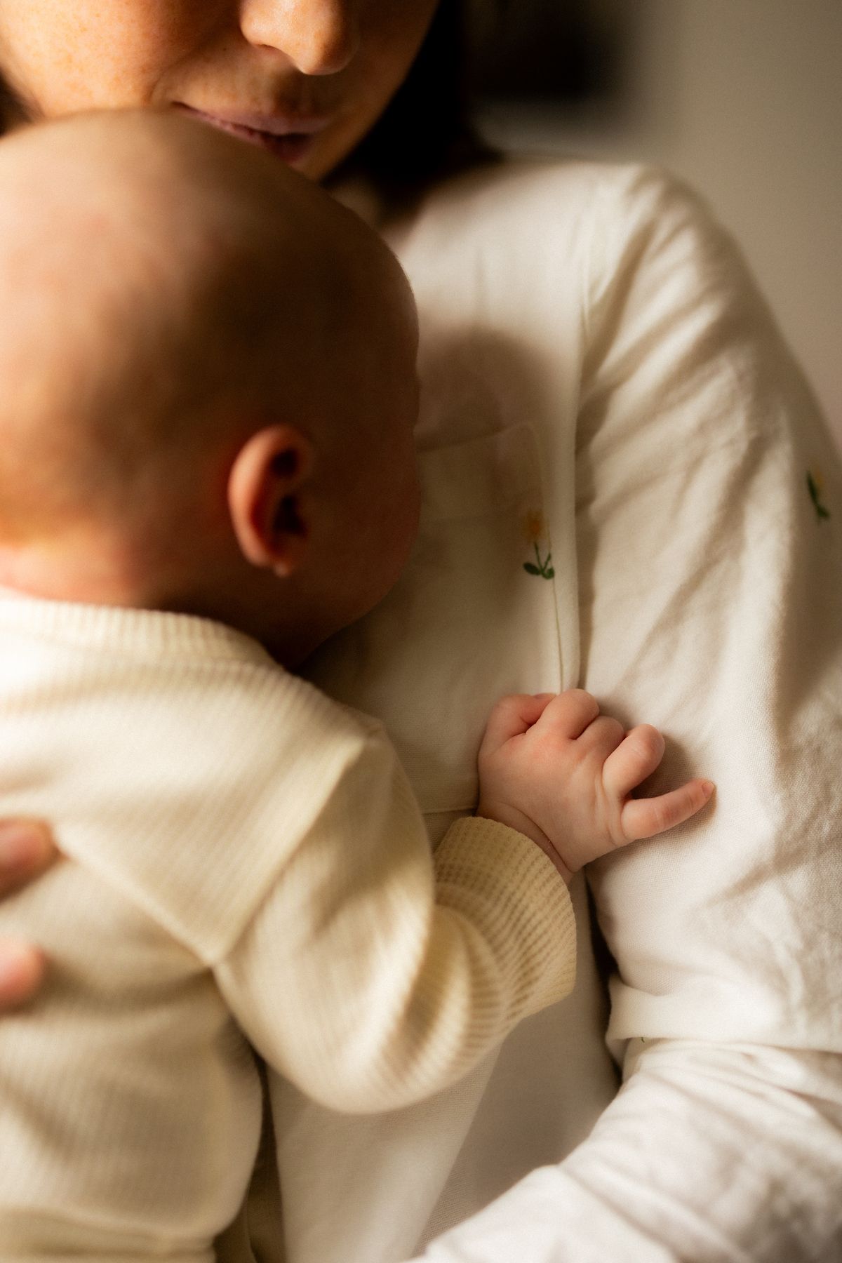 Close-up soft focus images of tender moments in white sweaters.